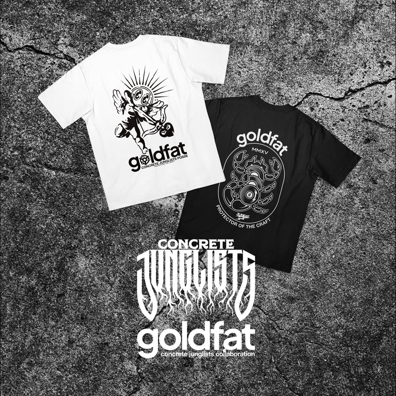 Two t-shirts with 'goldfat' branding on a textured surface